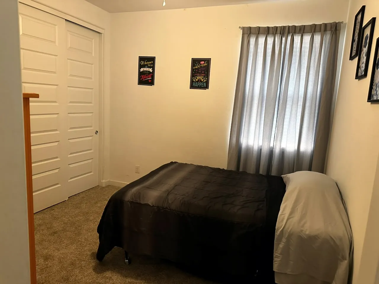Youth bedroom with a built-in closet, window curtains and inspirational posters